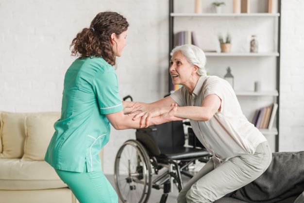 young-nurse-assisting-disabled-senior-woman